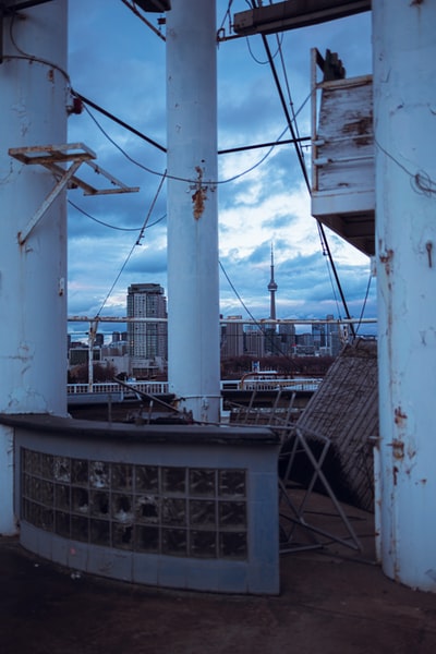 White wind turbines with the top of the building during the day
